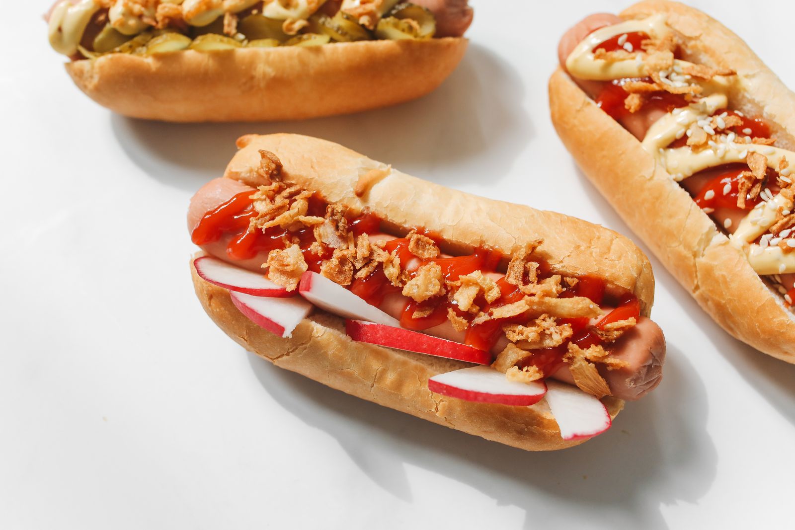 Grilled split hot dog with mustard and onion