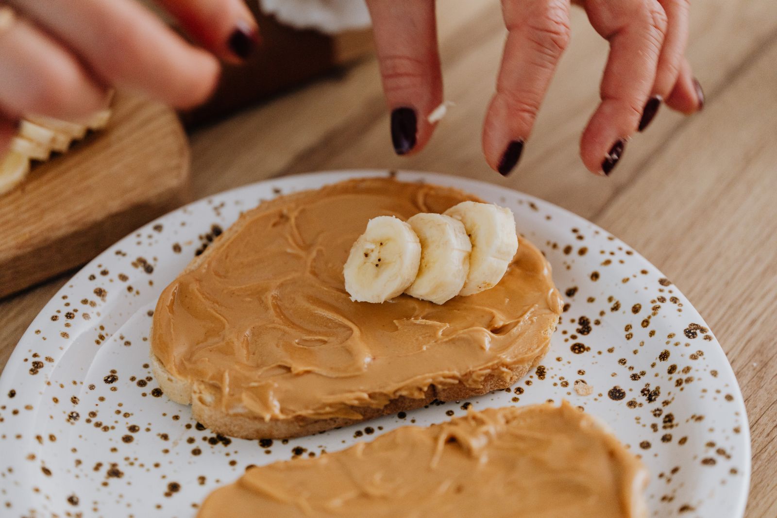 Peanut butter on bread with fresh banana slices