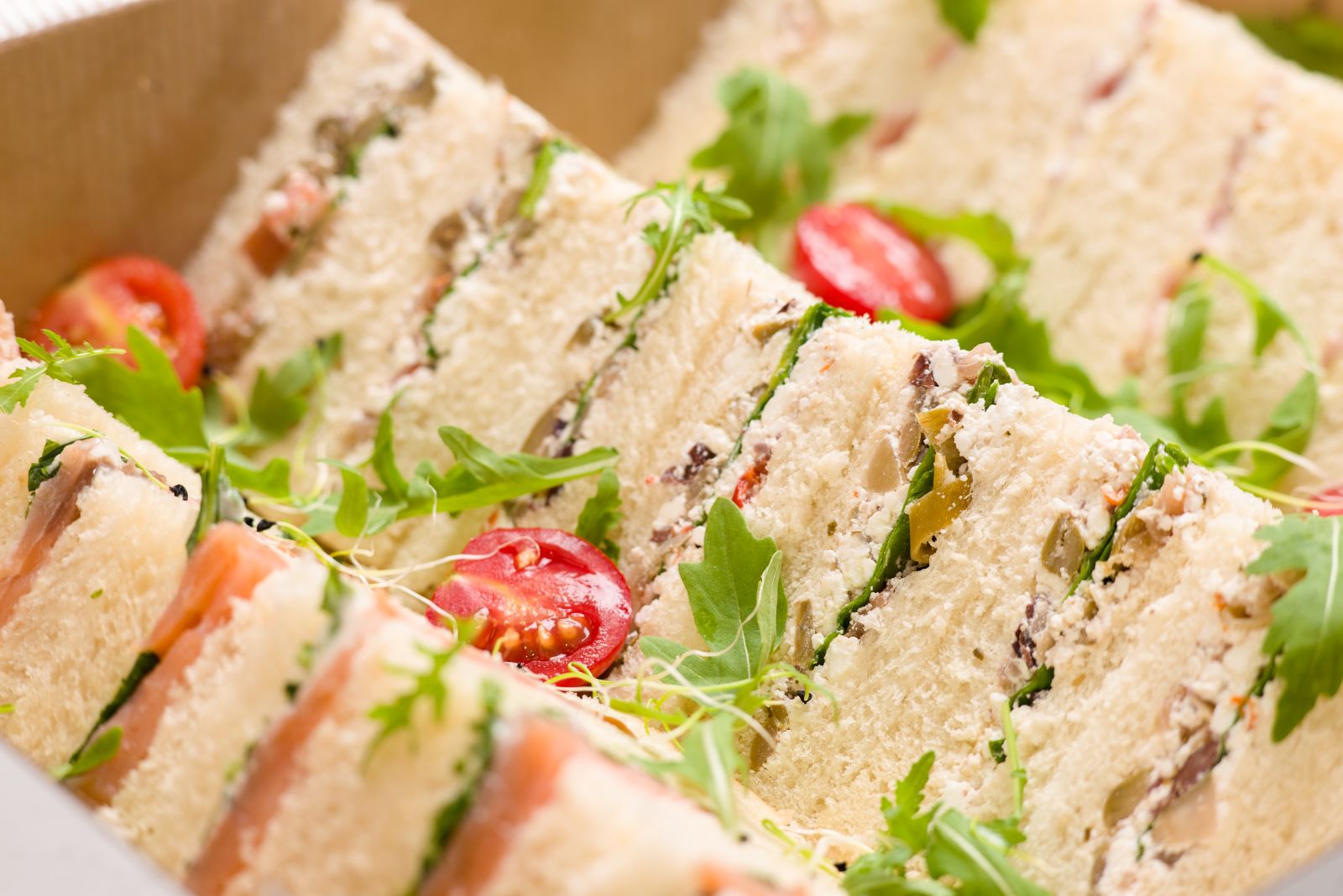 Stack of white bread sandwiches cut on the diagonal, old fashioned sandwiches