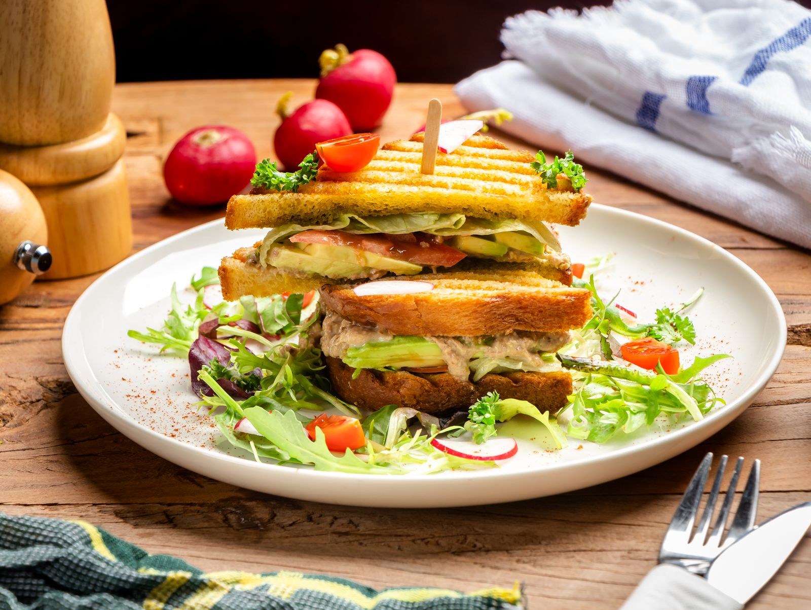 Toasted sandwich stack on a plate with lettuce, old fashioned sandwiches