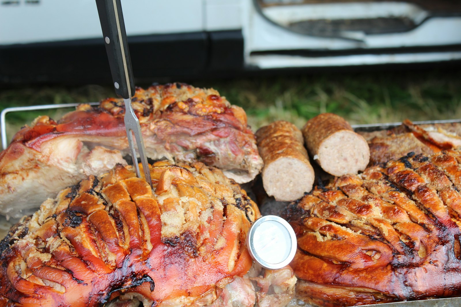 Bacon wrapped roast with crisp edges, sliced on a tray