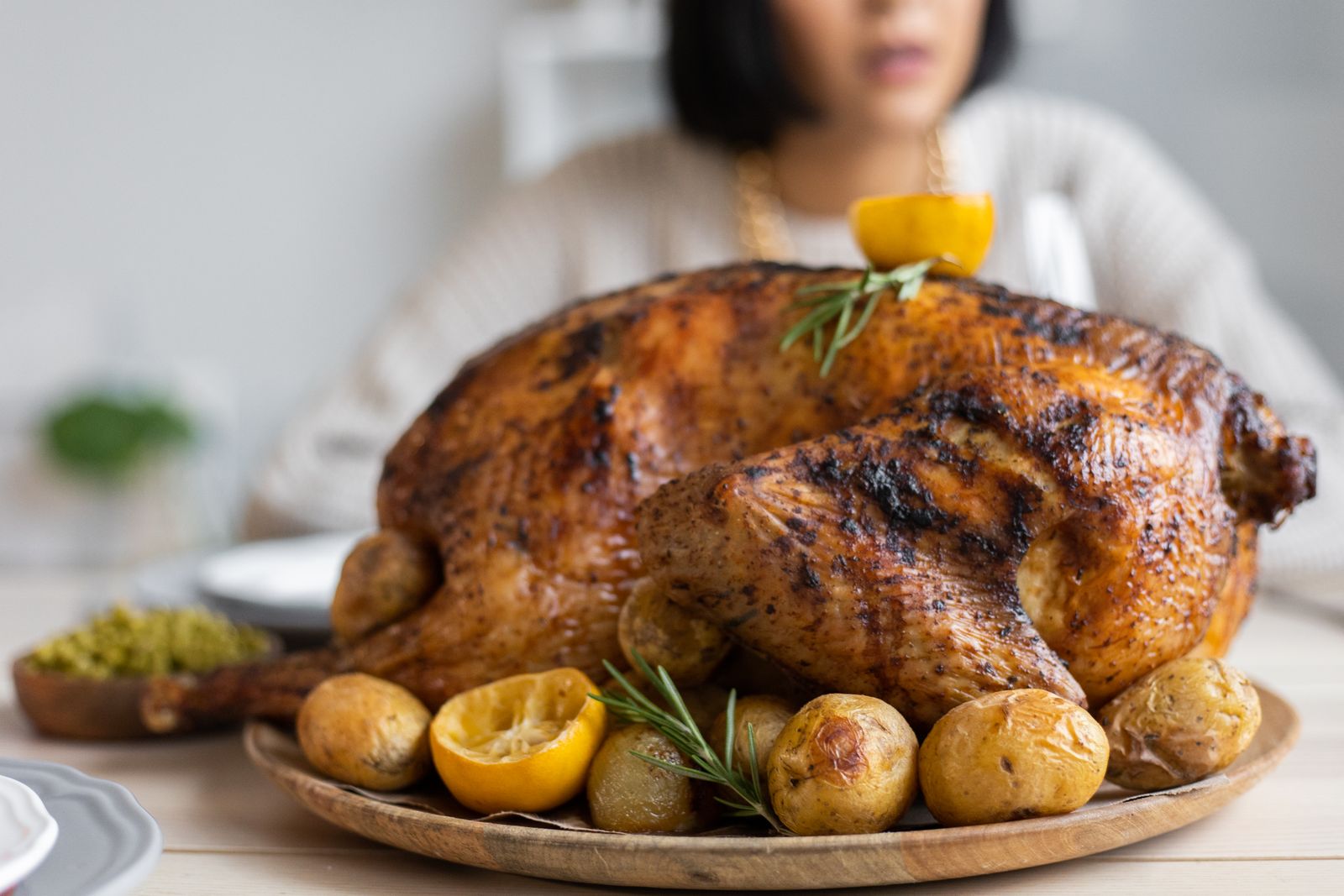 Golden roast bird with lemons and potatoes