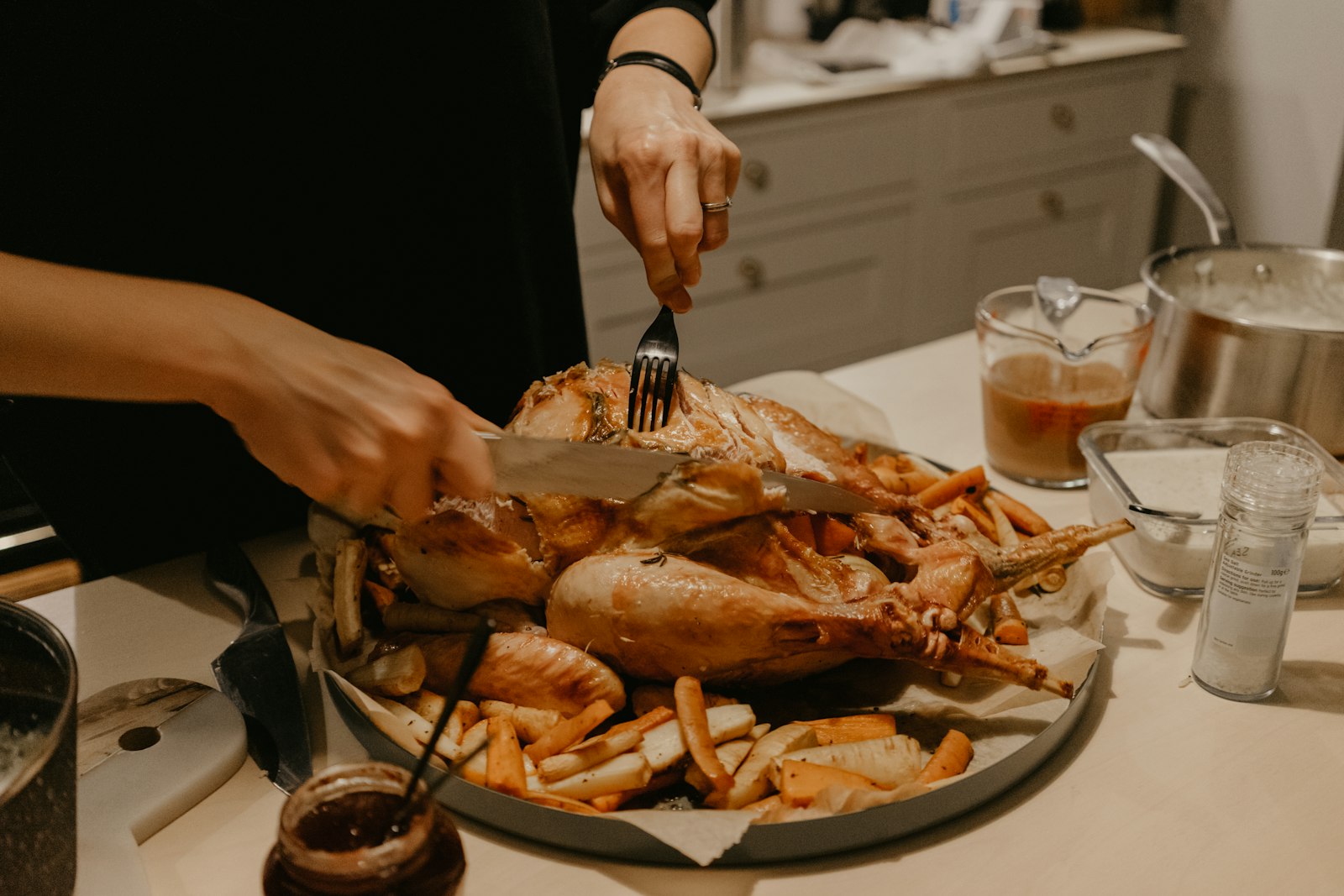 Flattened roast bird being served at the table