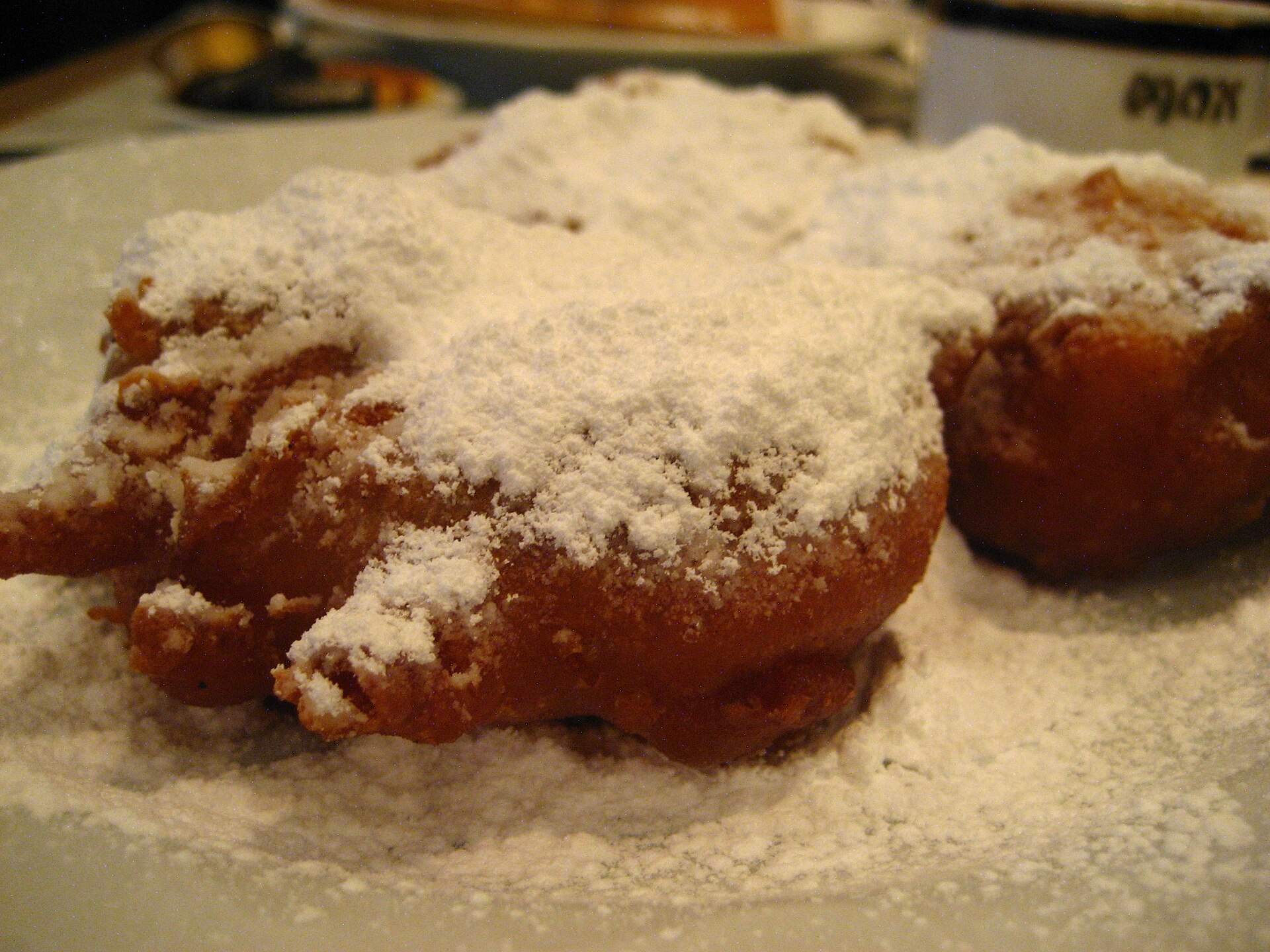 Apple fritters dusted with powdered sugar, the way the 1927 cookbook suggests