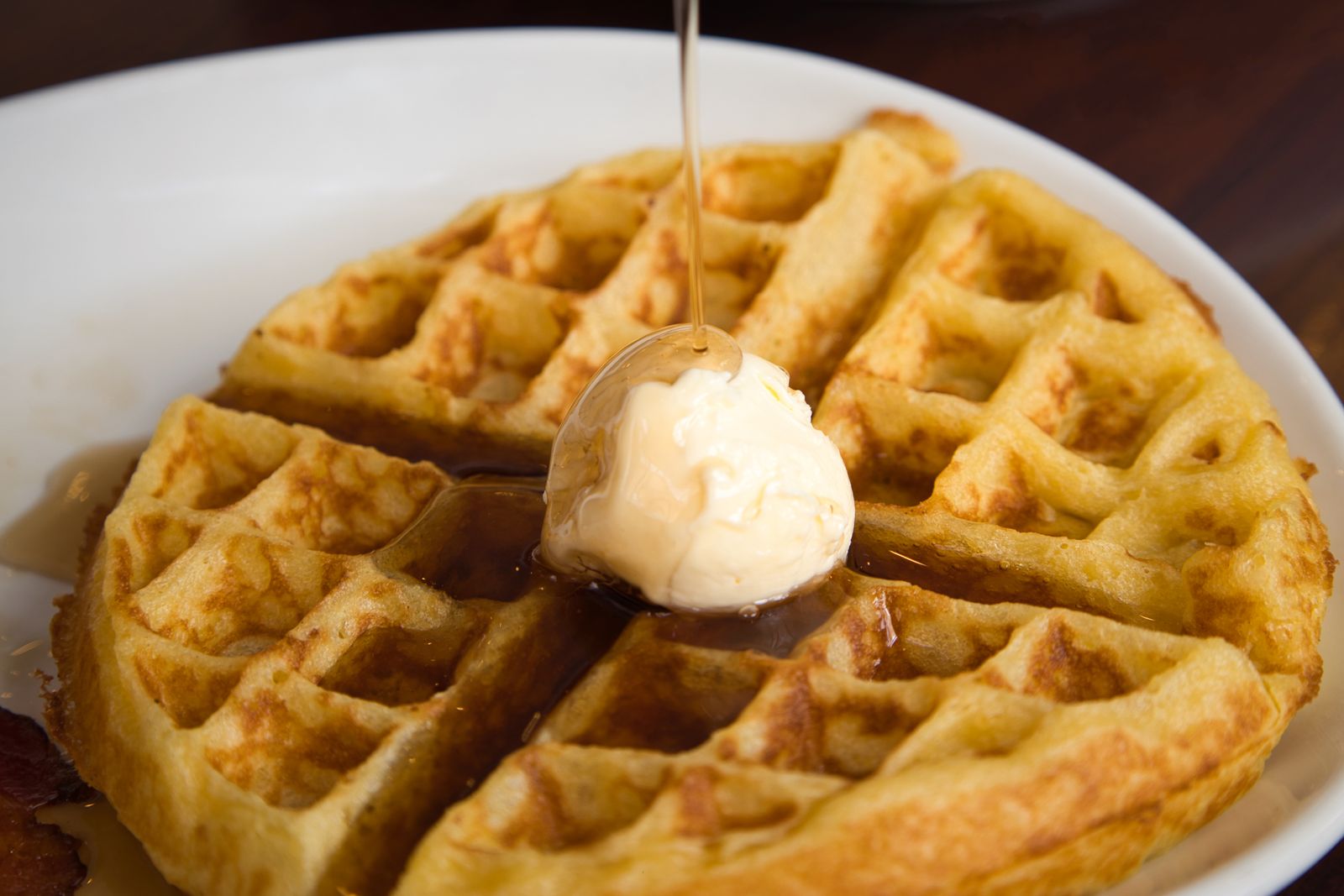 Golden waffle with butter and syrup