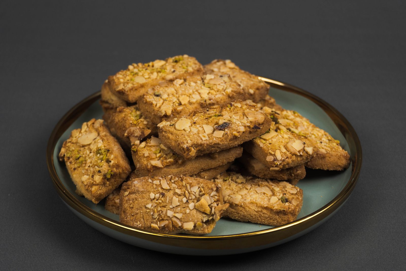 Almond flour cookies with pistachios on a blue plate