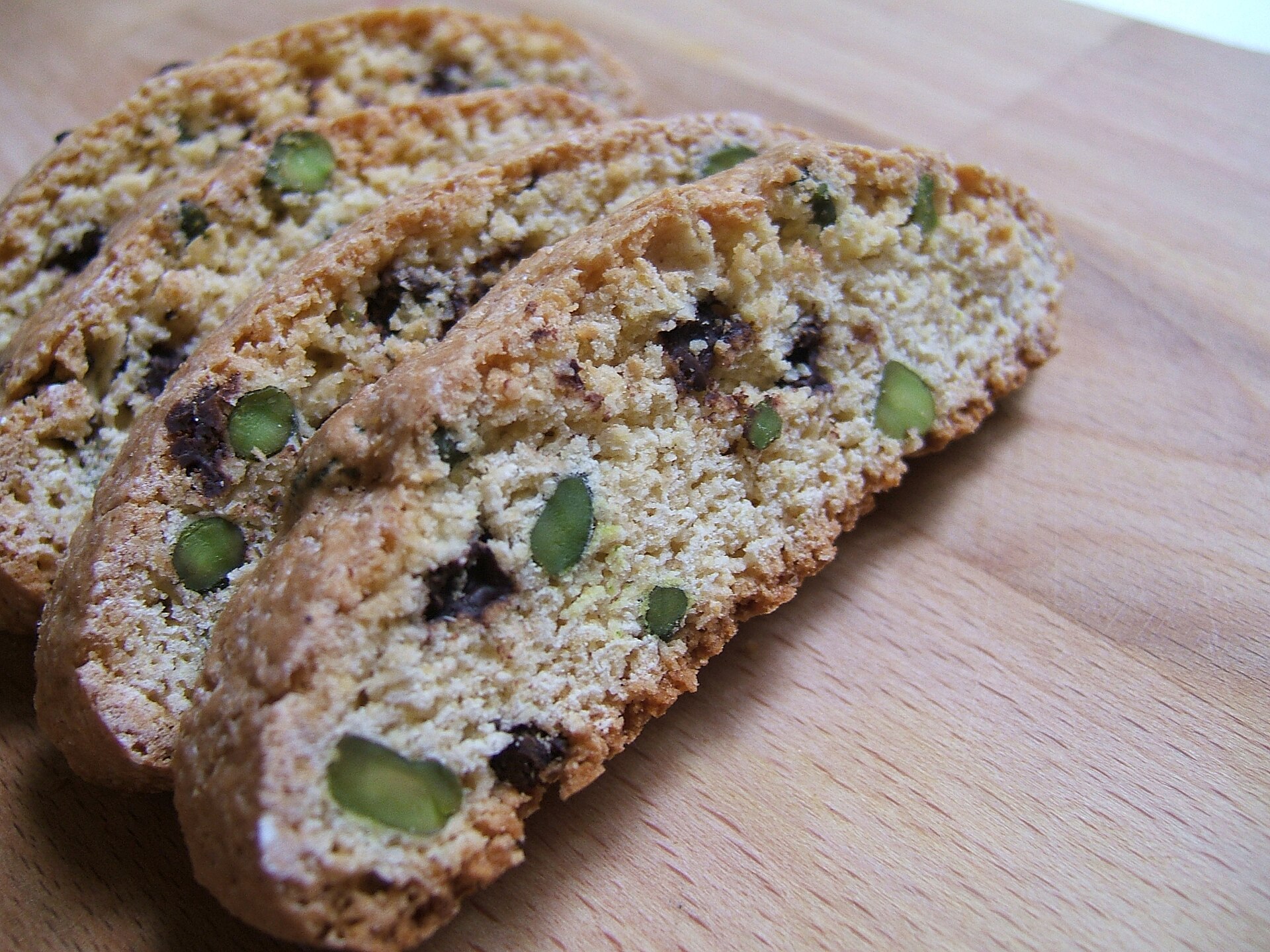 Biscotti with pistachios and chocolate chips on a wooden table