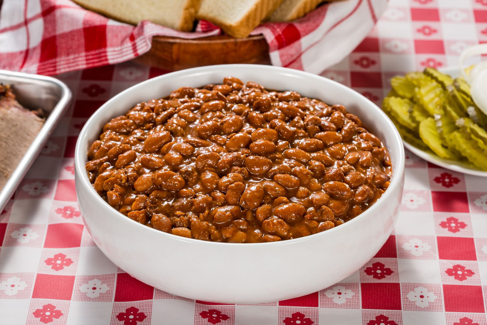 Bowl of saucy cowboy beans on a picnic table