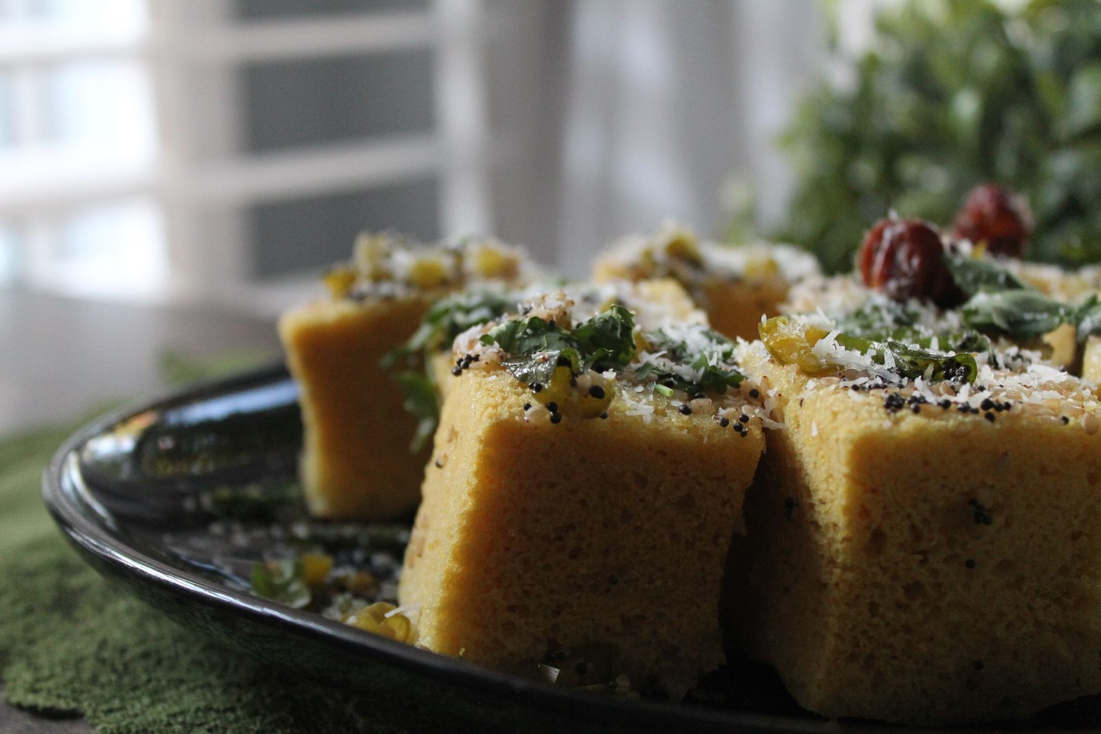 Squares of cornbread topped with herbs and cheese