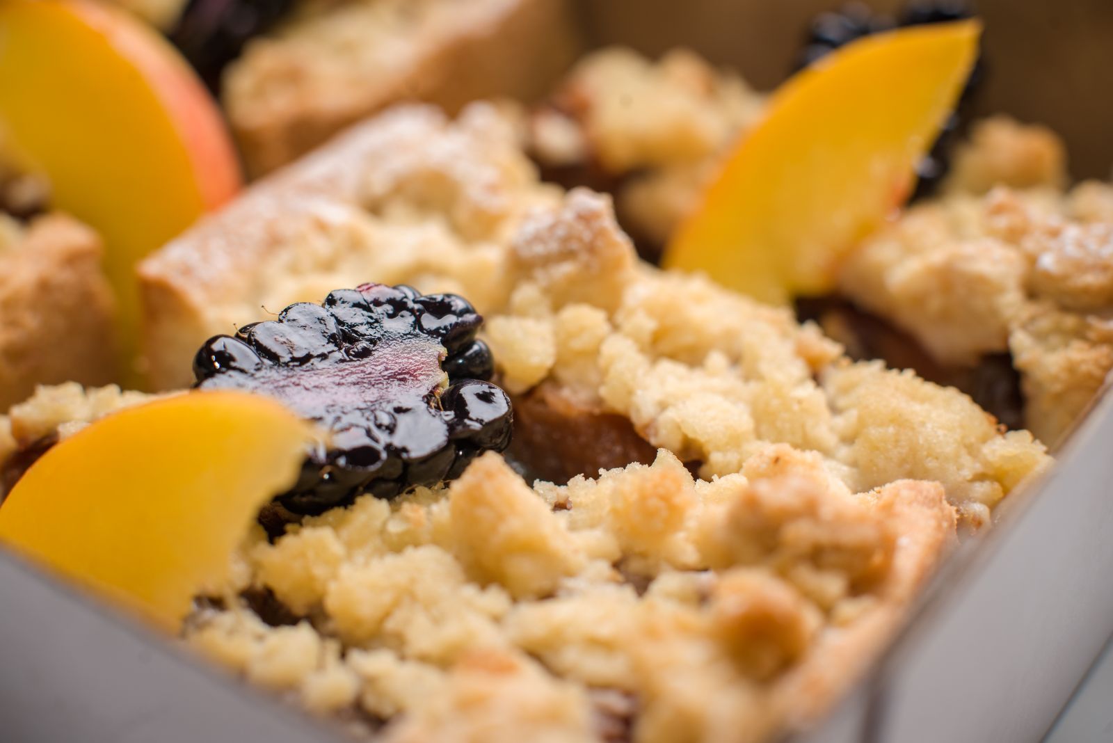 Peach and berry crumble with golden topping