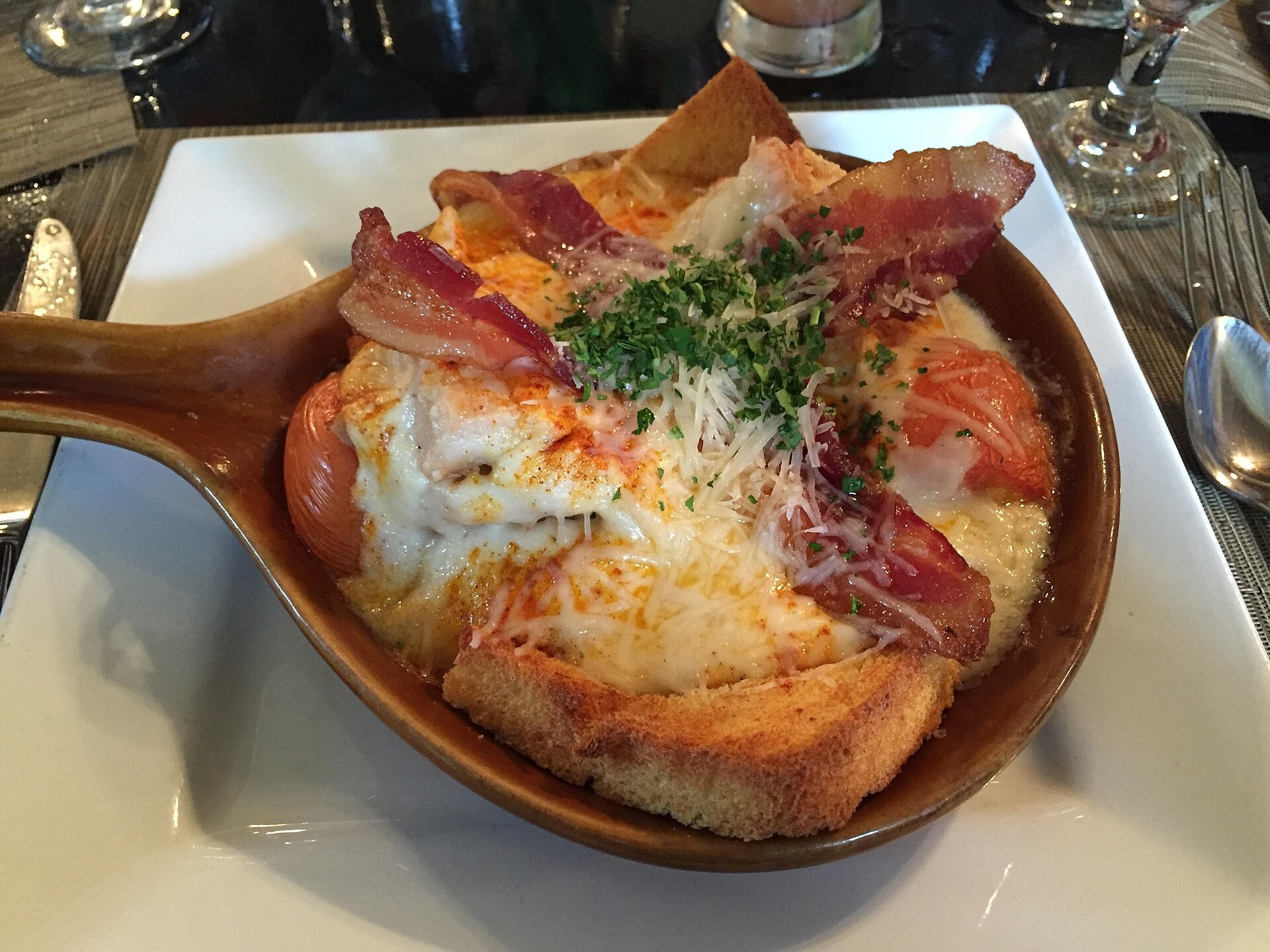 Hot Brown open faced turkey sandwich with cheese sauce and bacon