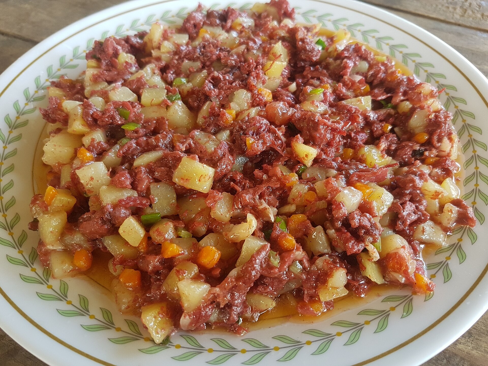 Canned corned beef sauteed with diced potatoes and tomato