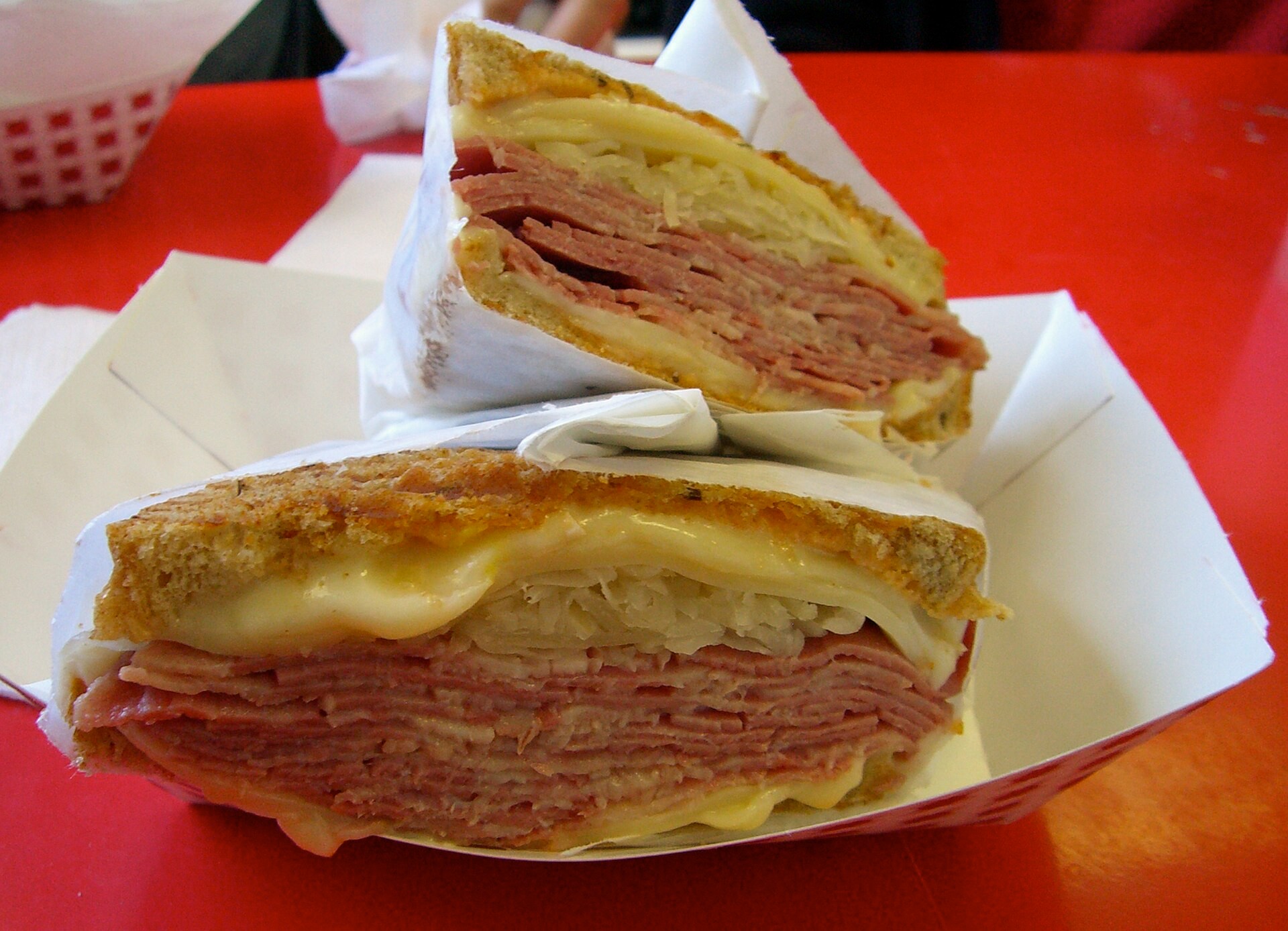 Grilled Reuben sandwich halves with melted Swiss and sauerkraut