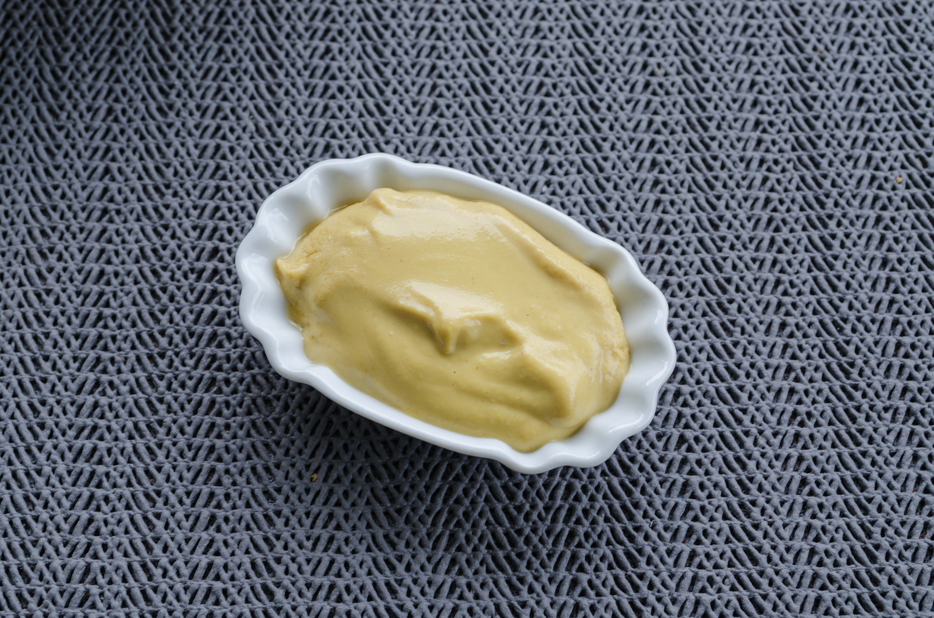 Smooth honey mustard in a small white dish