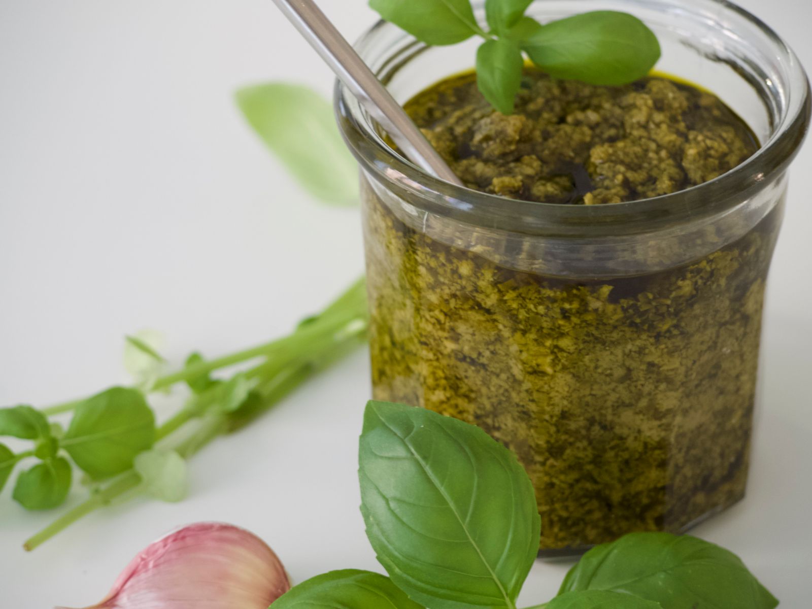 Homemade basil pesto in a glass jar