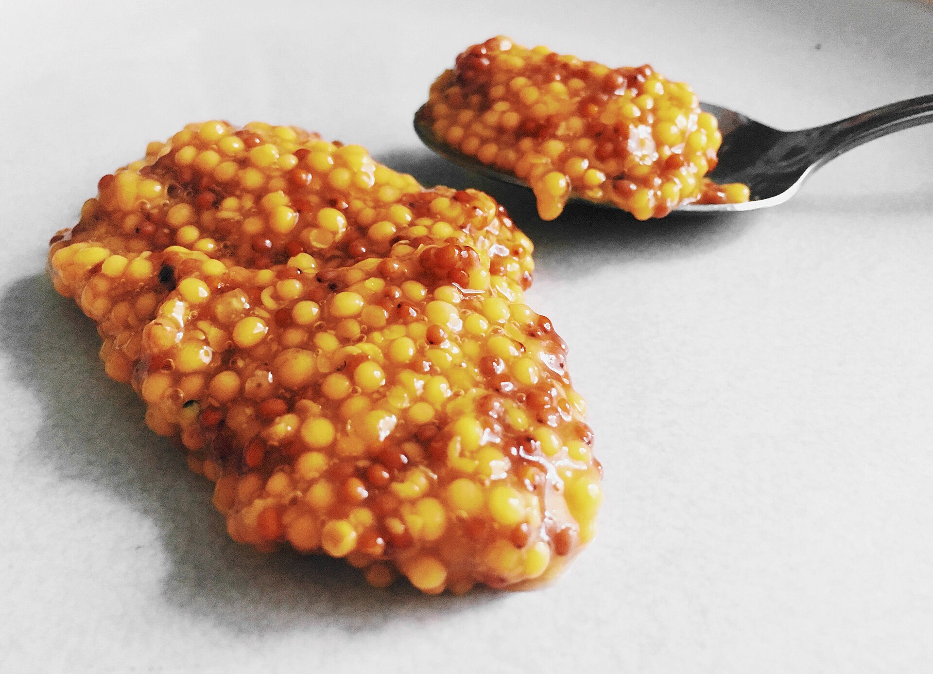 Whole grain mustard on a spoon