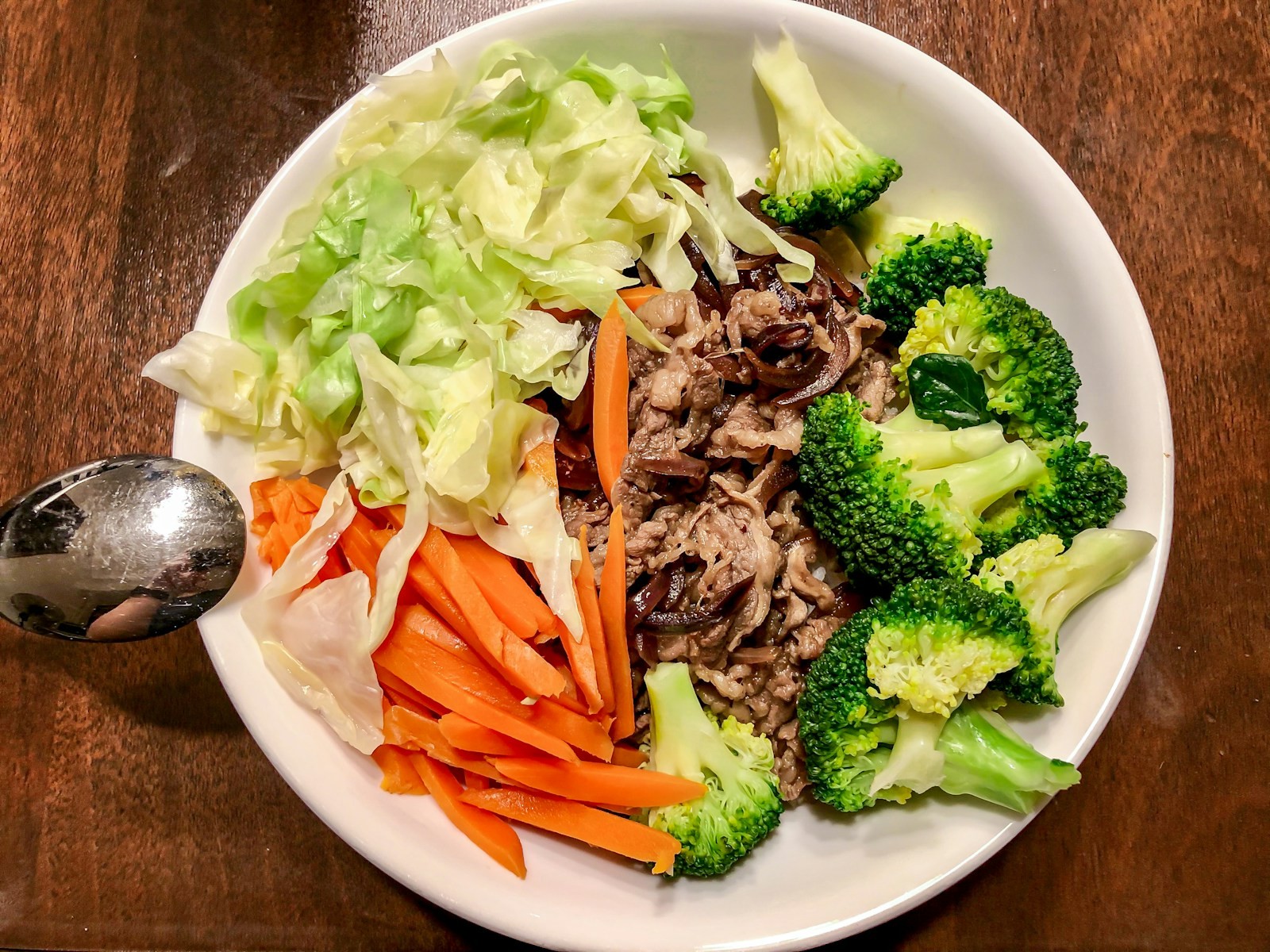 Bowl of broccoli, cabbage, carrots and sliced beef