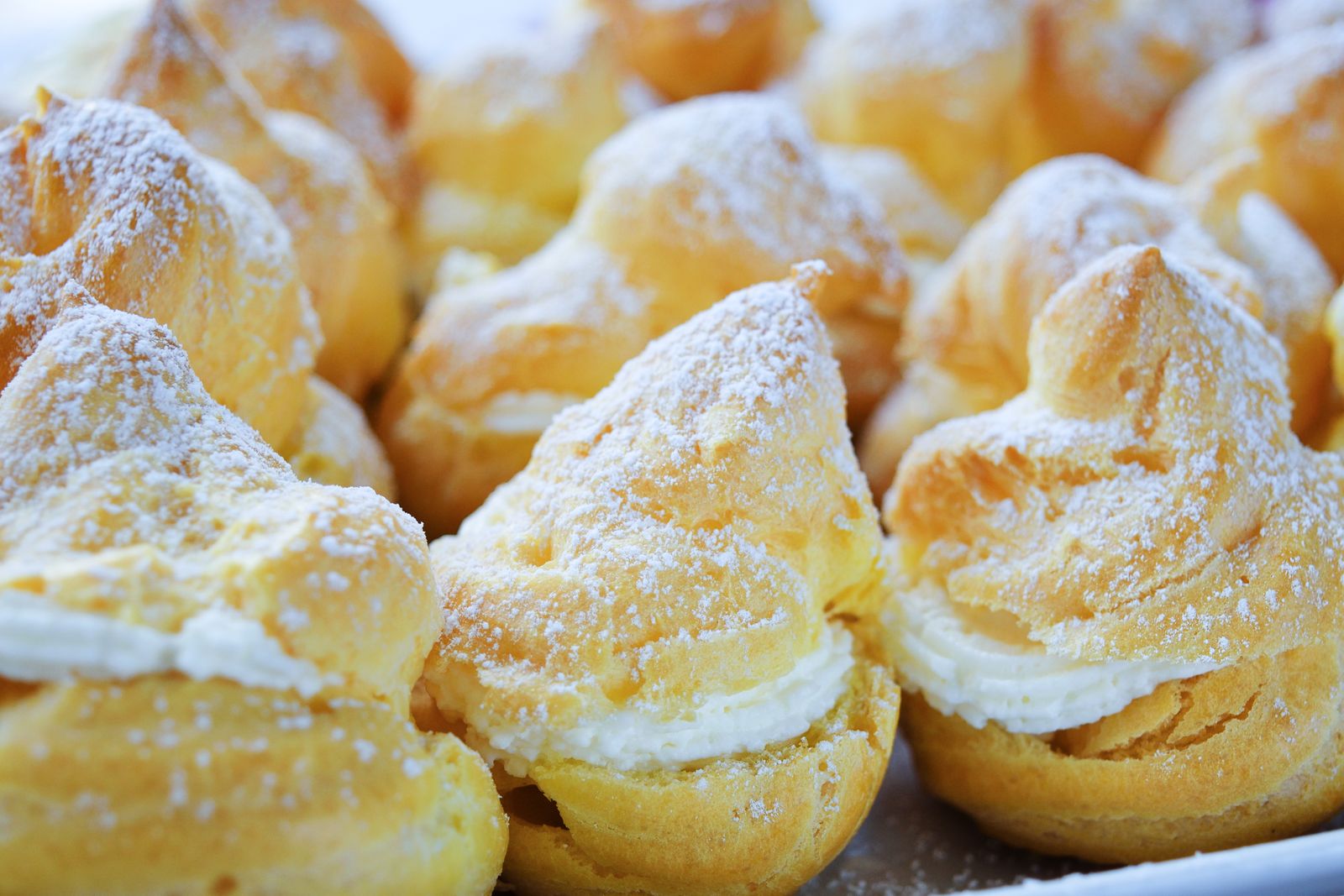 Cream puffs filled with whipped cream and dusted with powdered sugar