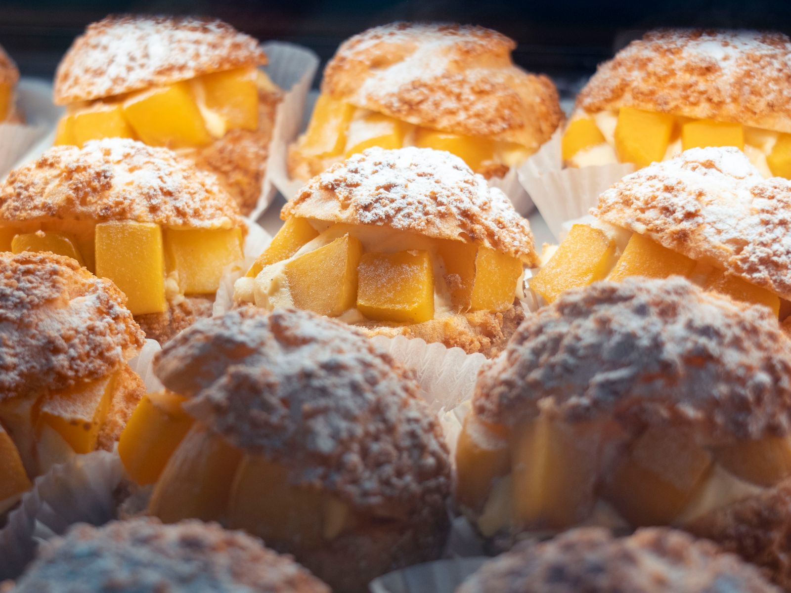 Craquelin cream puffs with a crackly top and fresh fruit filling