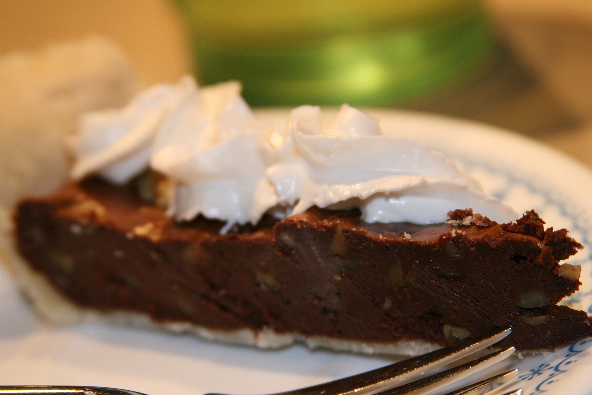 A rich chocolate fudge pie with whipped cream