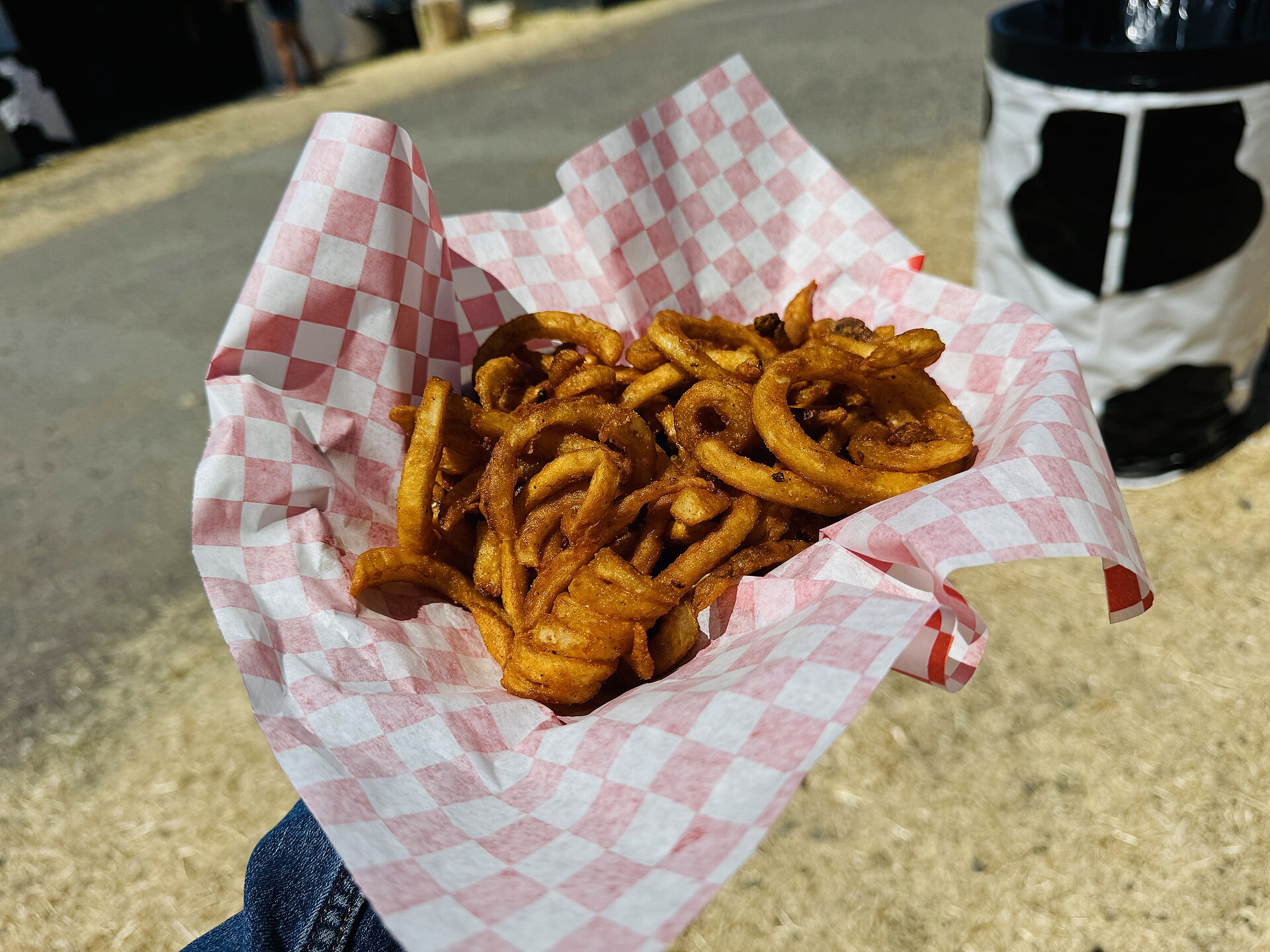 State fair foods snack: seasoned curly fries in a paper boat