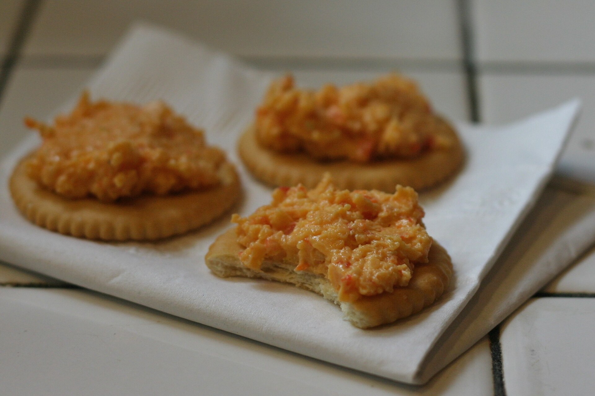Cheesy pimento cheese bites on parchment