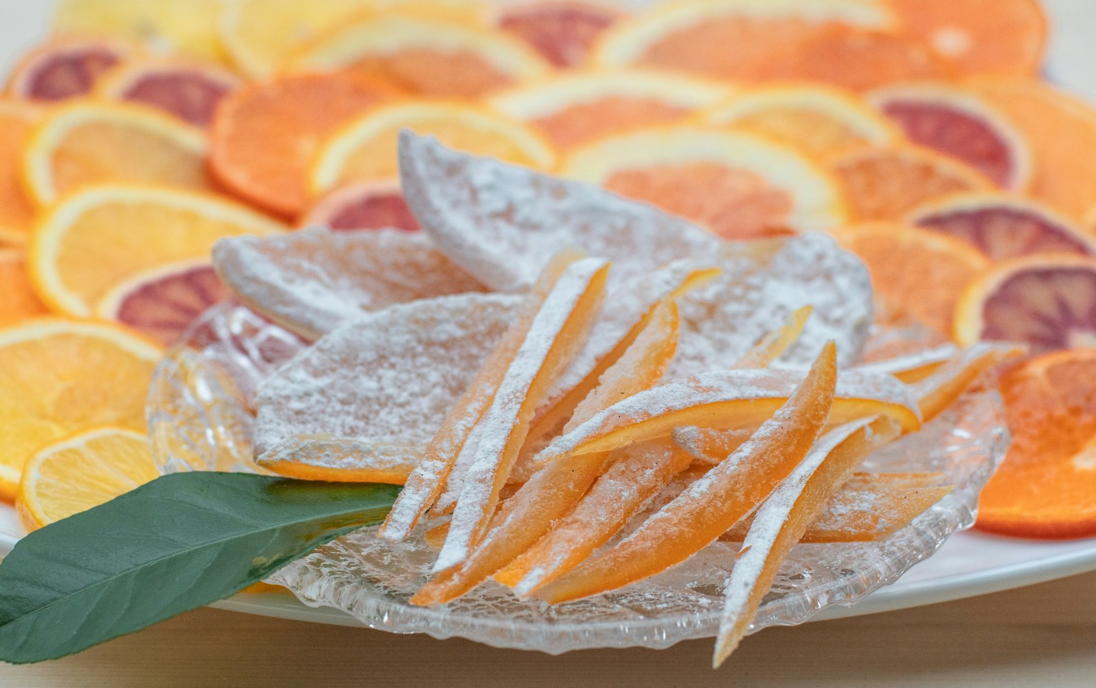Candied orange peel strips on a glass plate, made from kitchen scraps