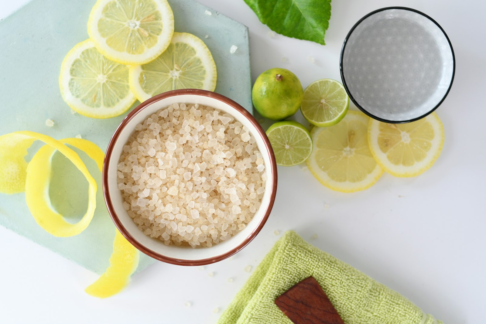 Lemon zest sugar in a bowl with fresh lemons