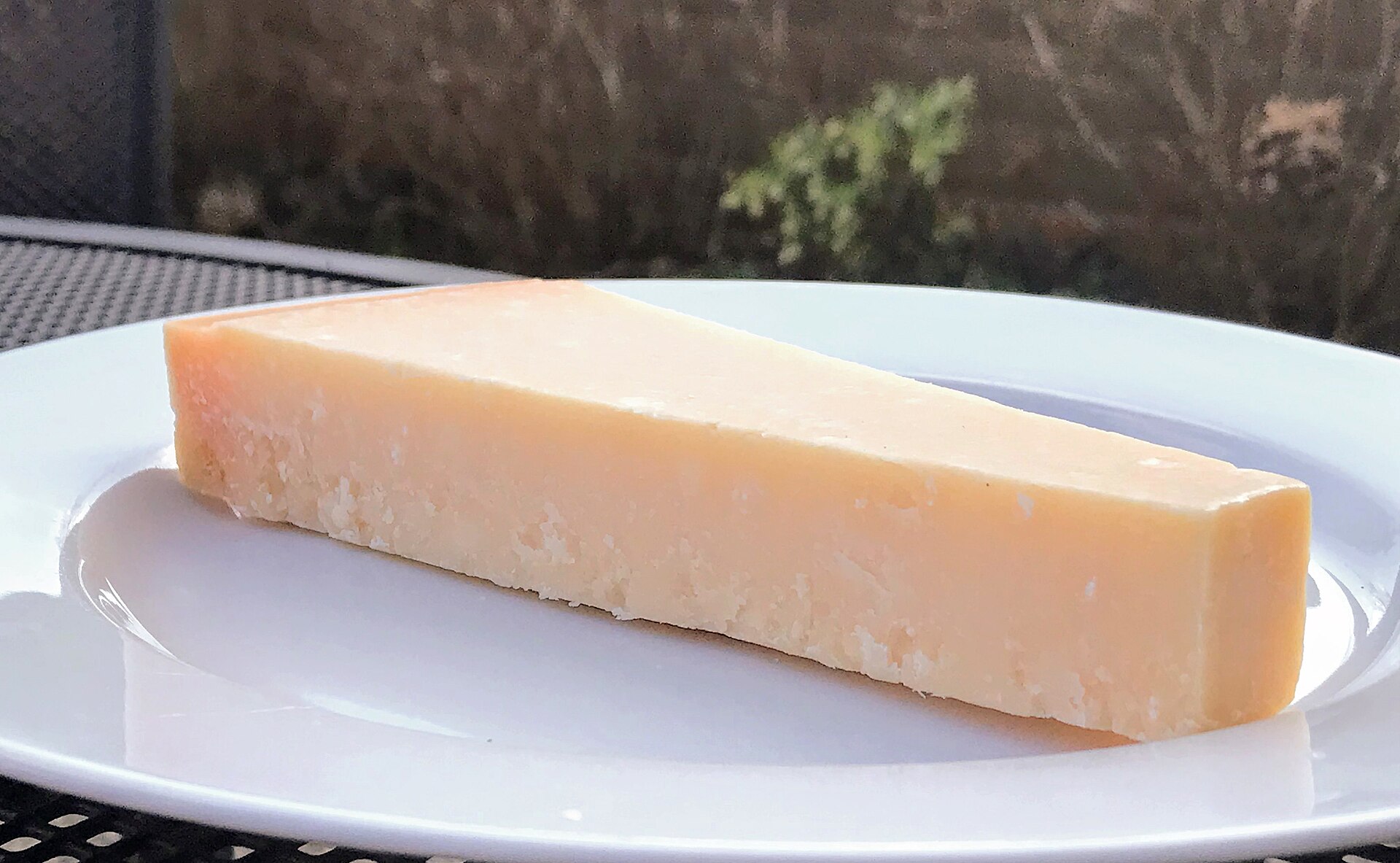Wedge of Parmesan with the hard rind on the edge