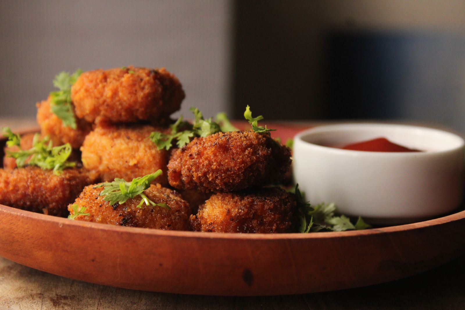 Crispy breaded bites with herbs and a tomato dip