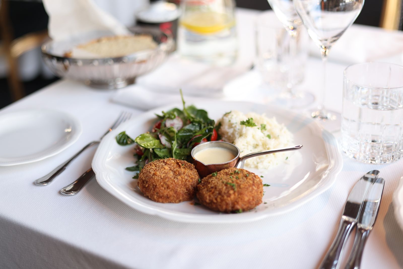Golden crab cakes plated with salad