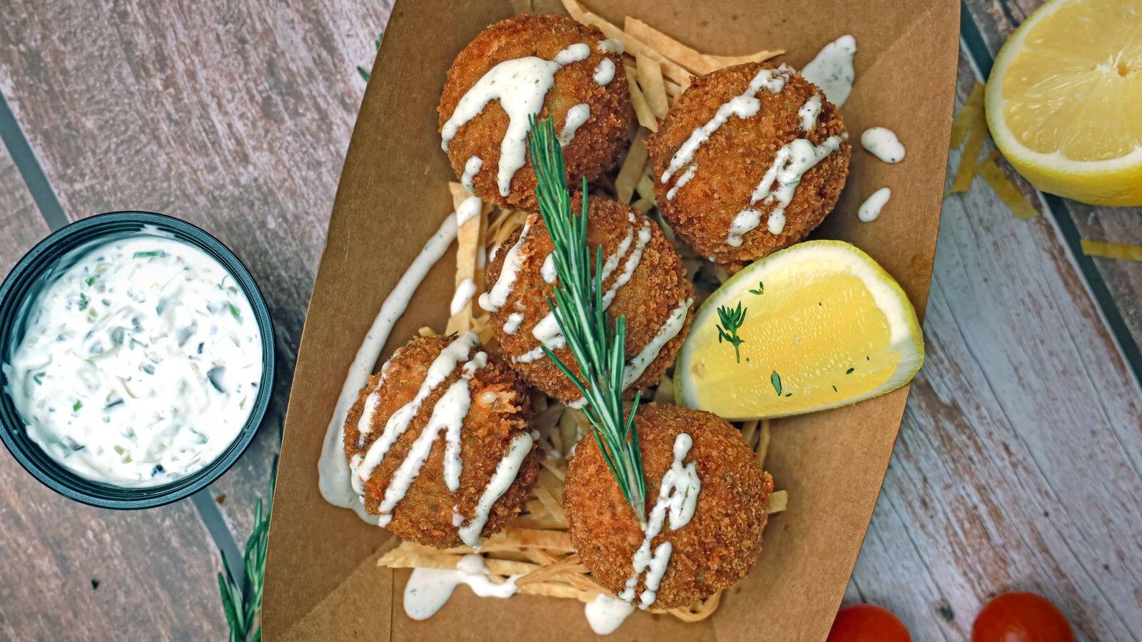 Crispy salmon croquettes with creamy sauce and lemon