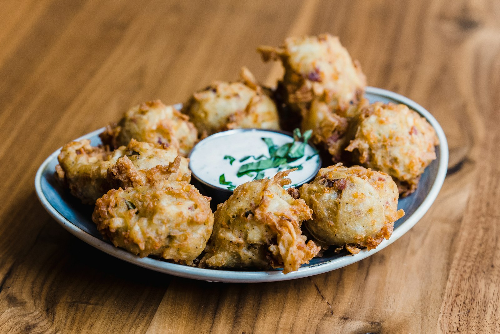 Crispy fried onion patties with a dip