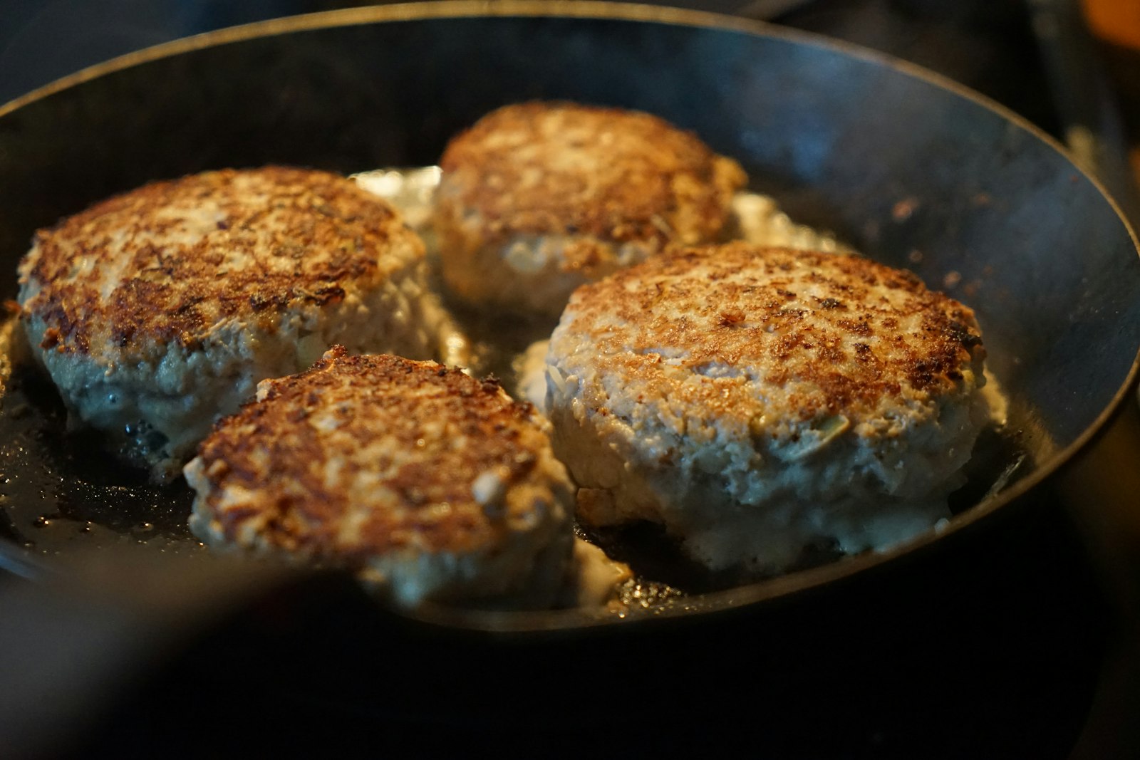 Mashed potato cakes browning in a skillet