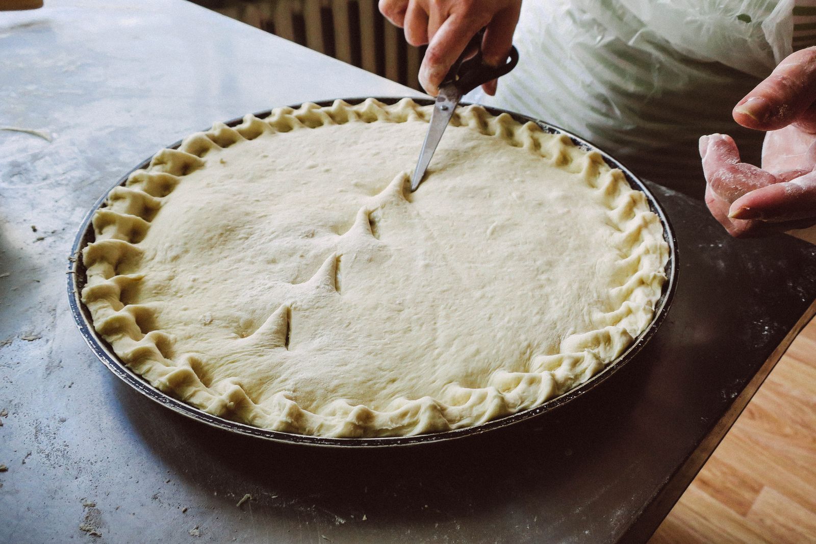 Fluted pie crust edge with steam vents cut in the top