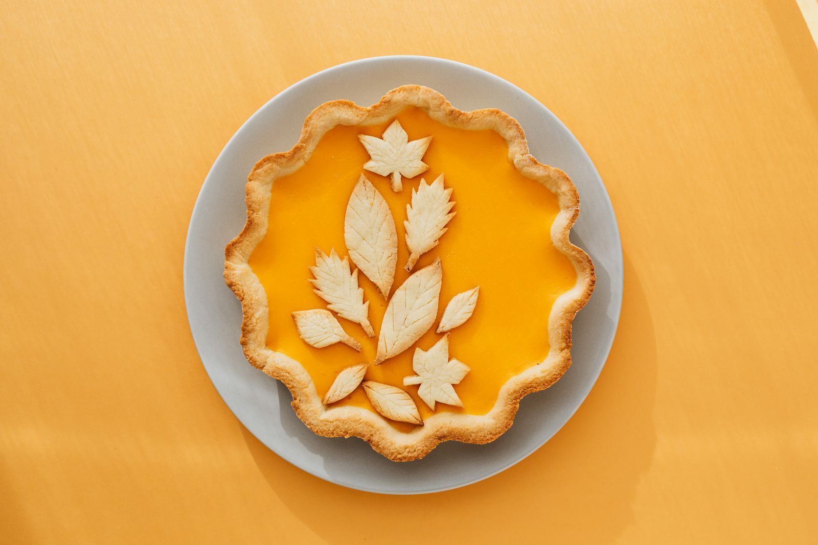 Pumpkin pie with a falling leaves pie crust design