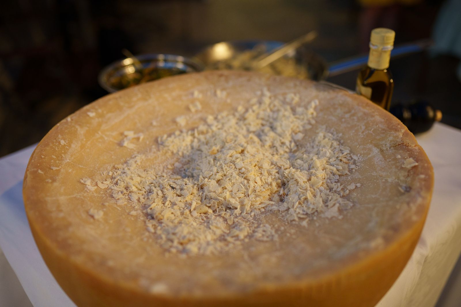 Cut Parmigiano Reggiano wheel showing the grainy cheese