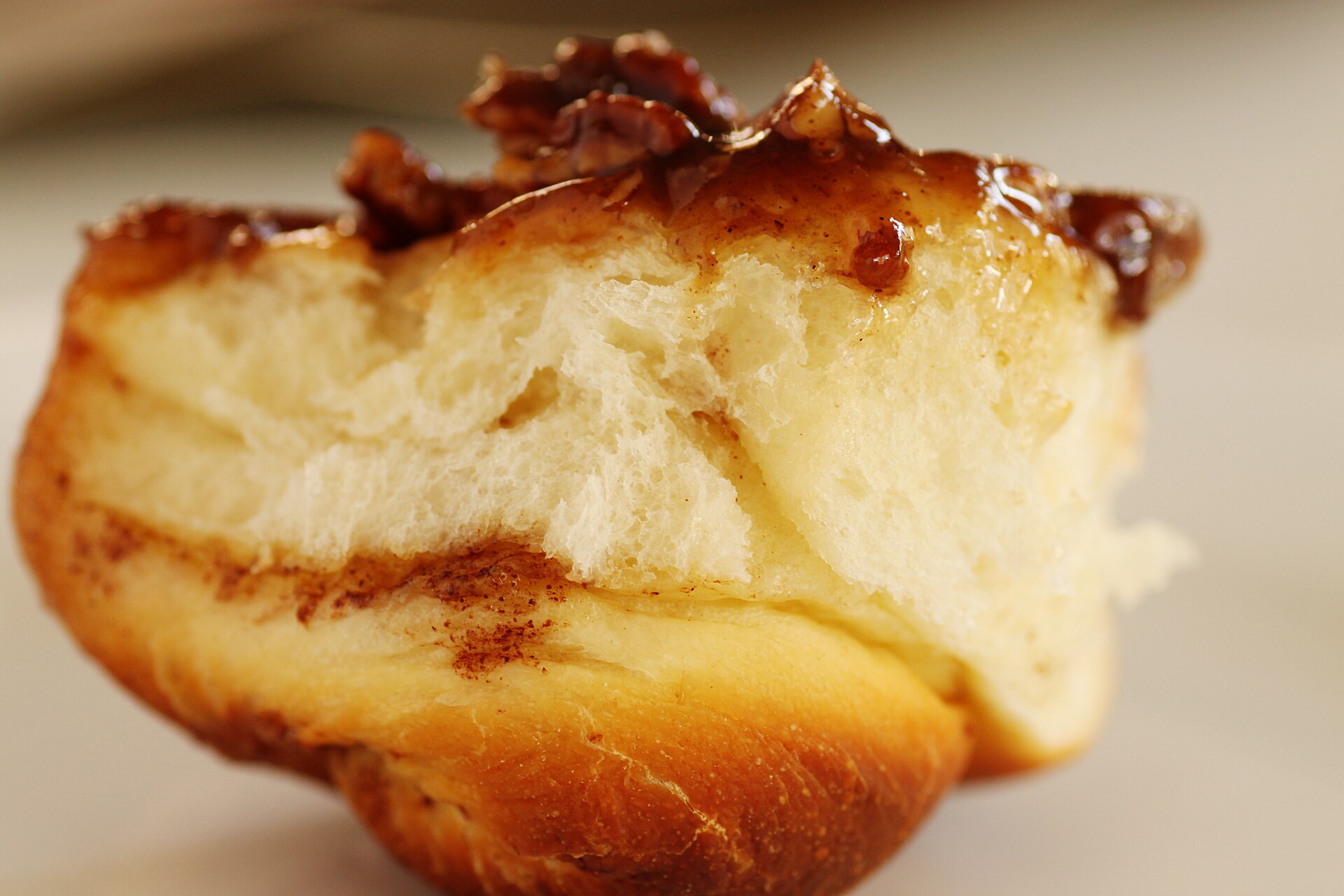 A soft caramel pecan sticky bun up close