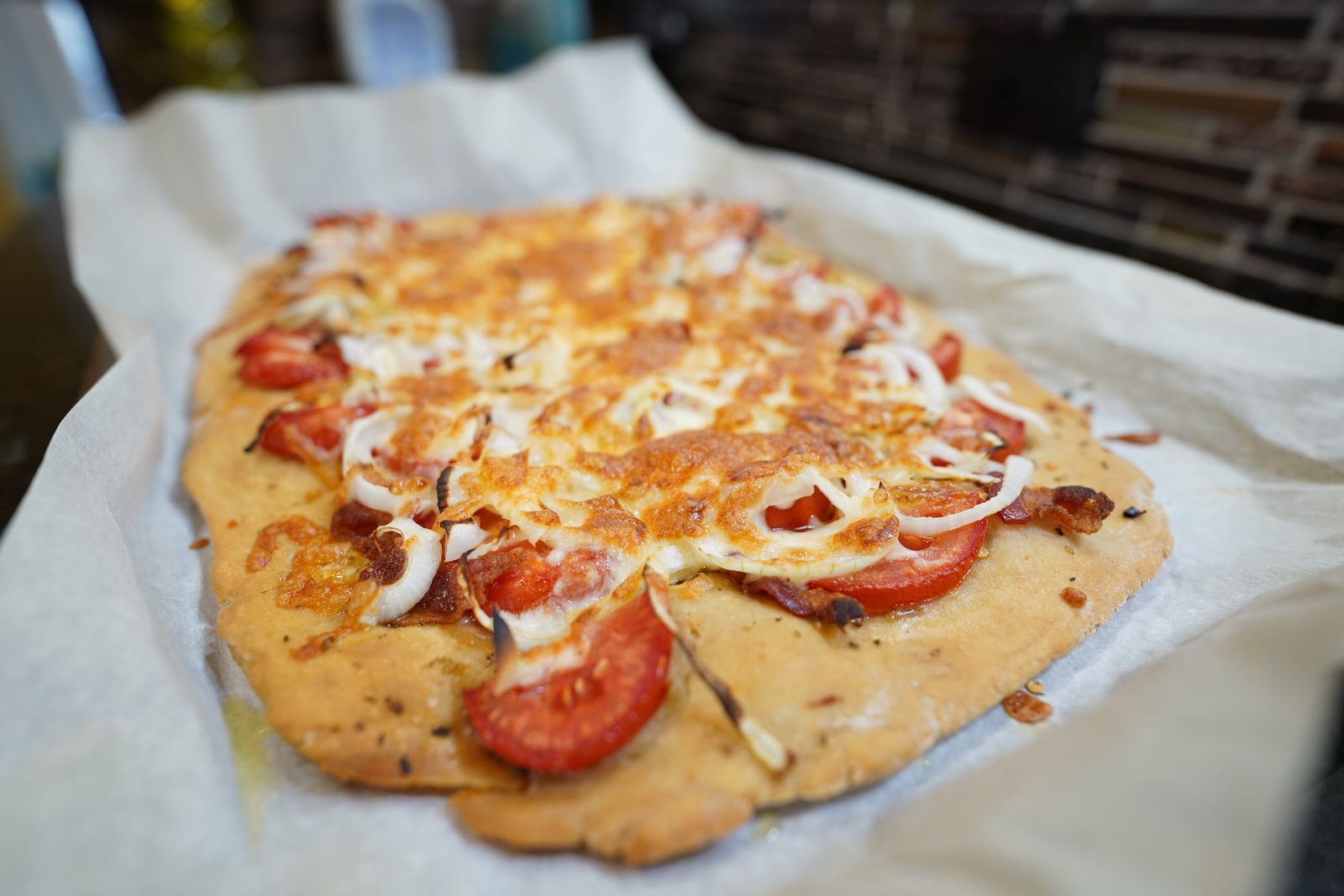 Homemade school lunch pizza with melted cheese and tomatoes