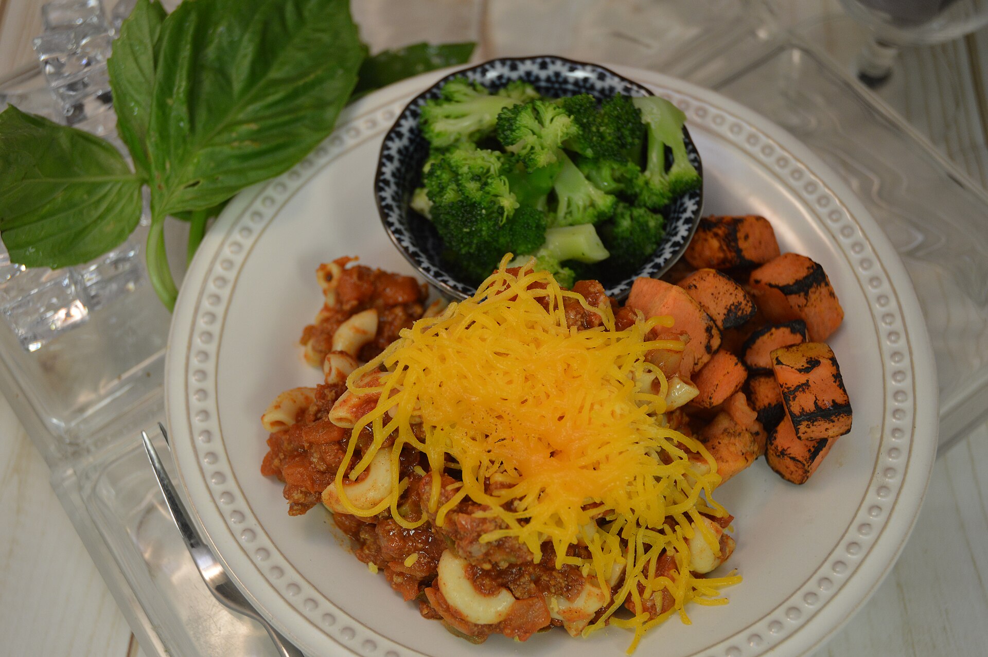 Chili mac with cheddar cheese on a plate