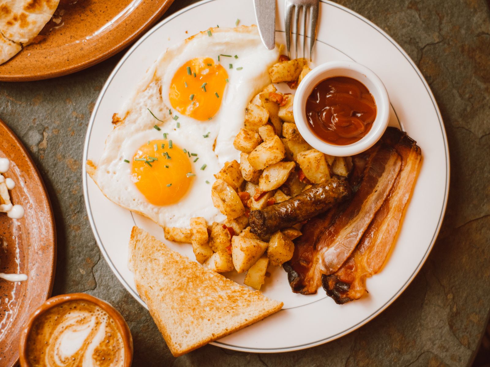 Struggle meals breakfast plate with fried eggs and crispy potatoes