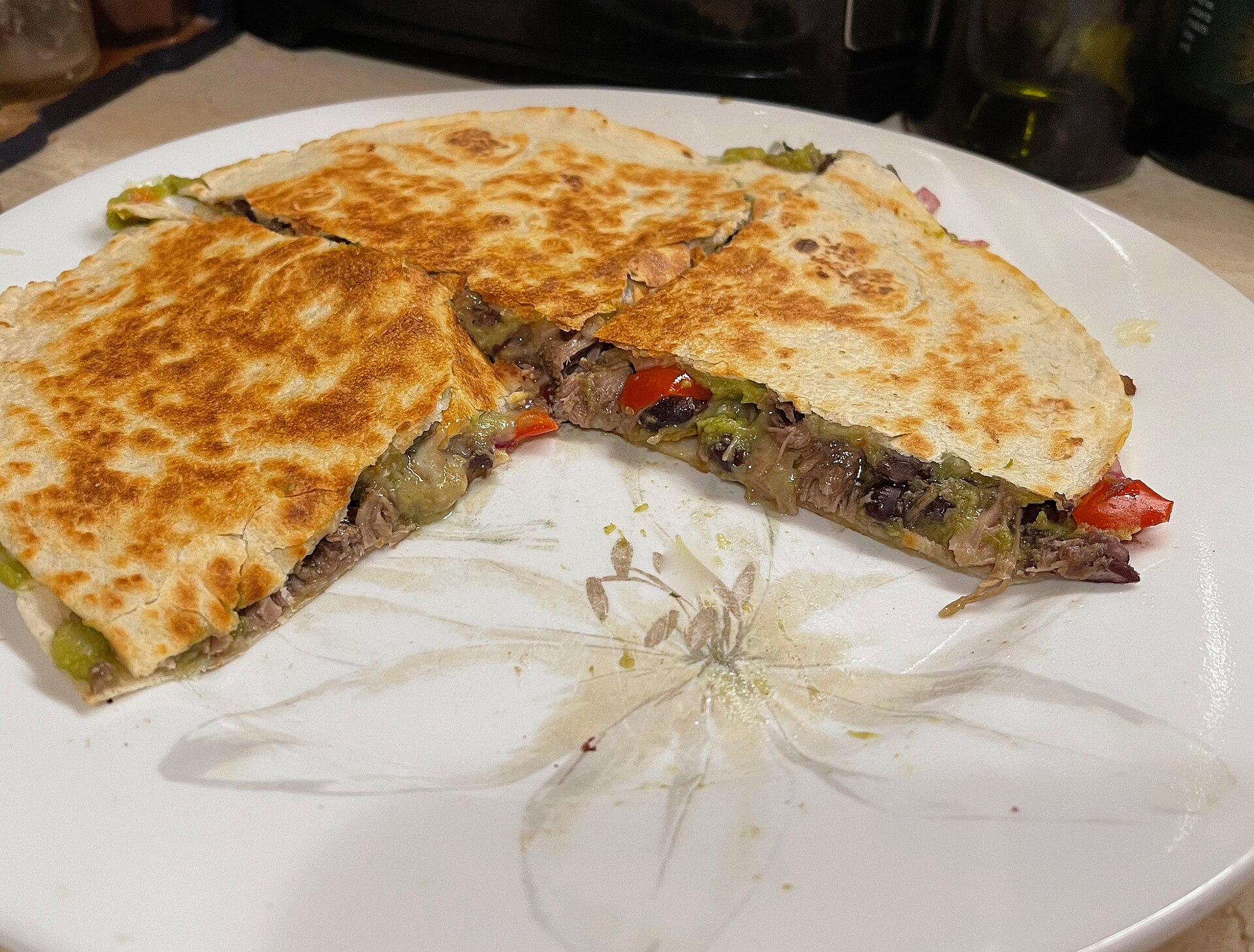 A crispy black bean quesadilla cut into wedges