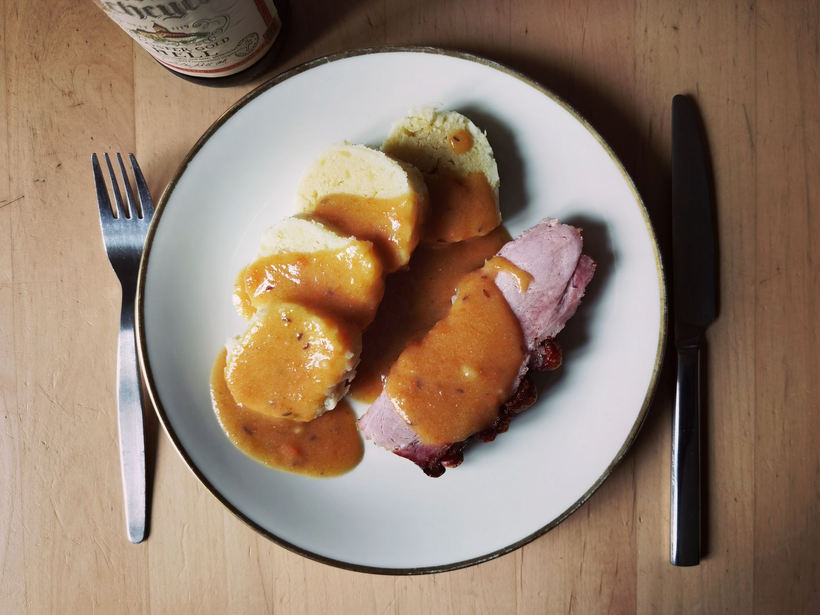 Sliced roast with rich brown gravy on a plate