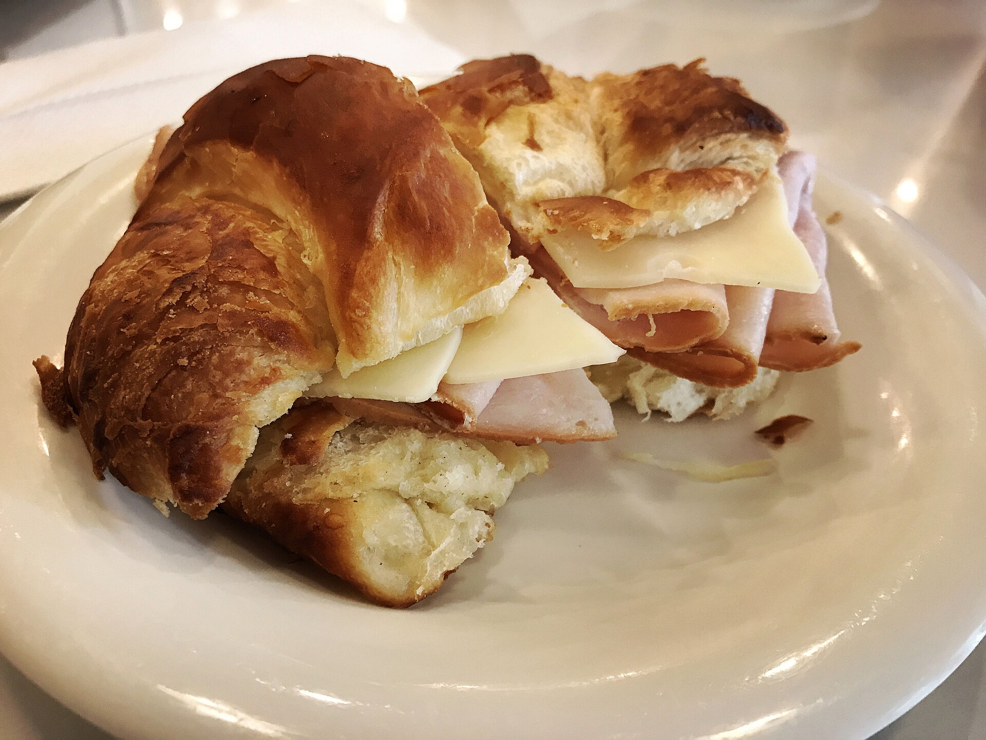 A leftover turkey sandwich on a flaky croissant