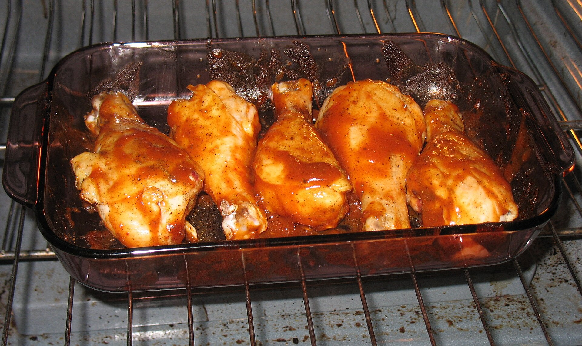 Barbecue chicken drumsticks baked in a glass dish