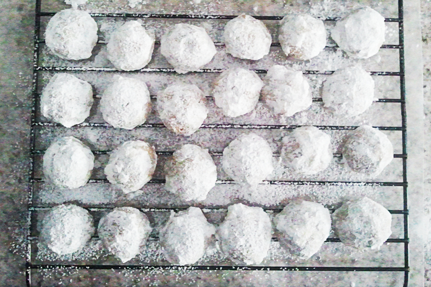 Powdered sugar snowballs on a cooling rack