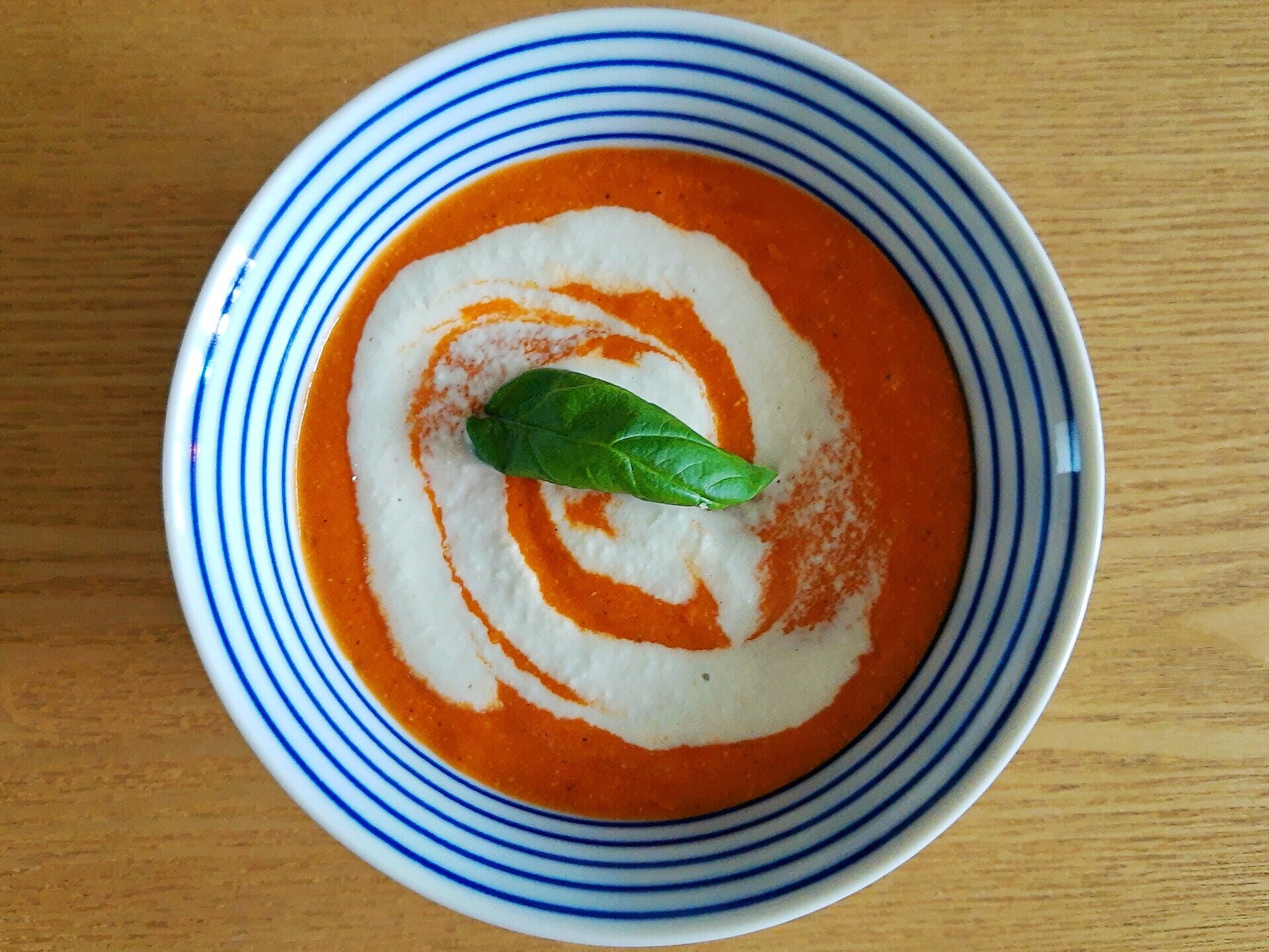Copycat restaurant soups: creamy tomato basil bisque with a swirl of cream