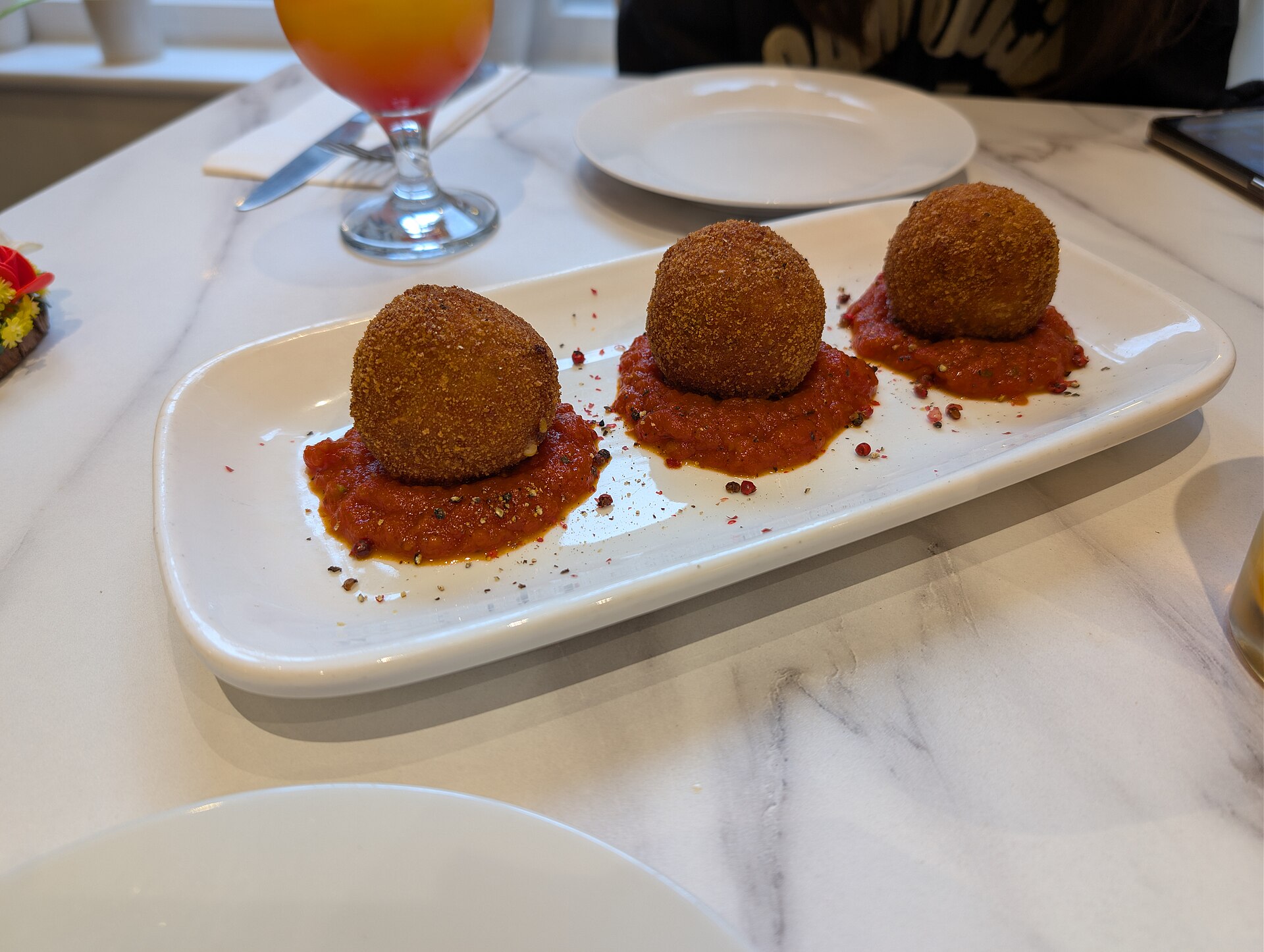 Sicilian arancini rice balls with tomato sauce
