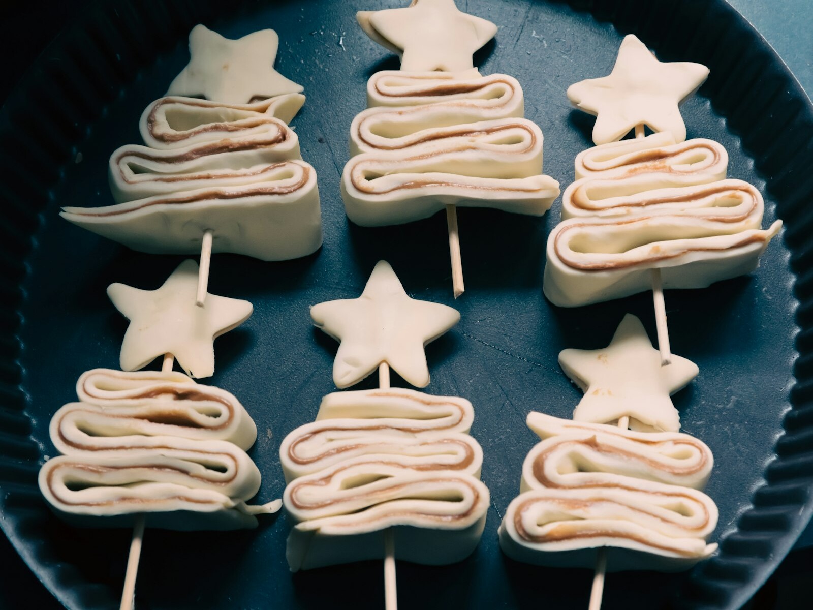 Puff pastry Christmas trees on sticks with star shapes