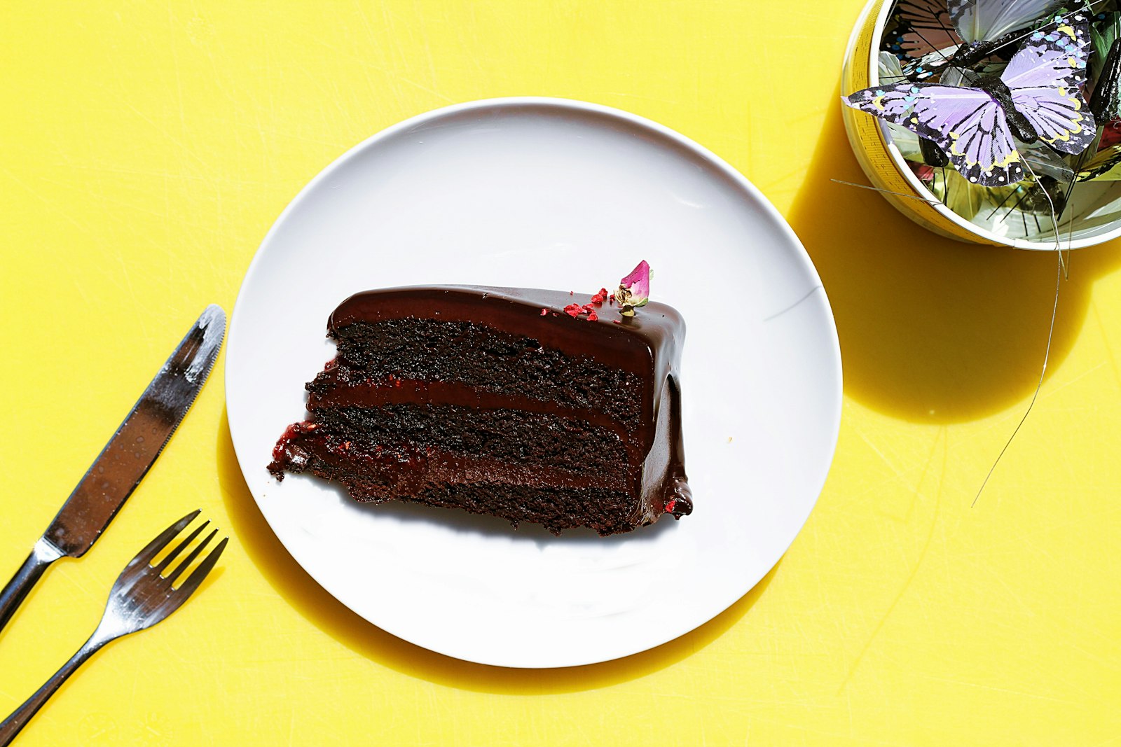 Slice of thin layered chocolate cake on a white plate